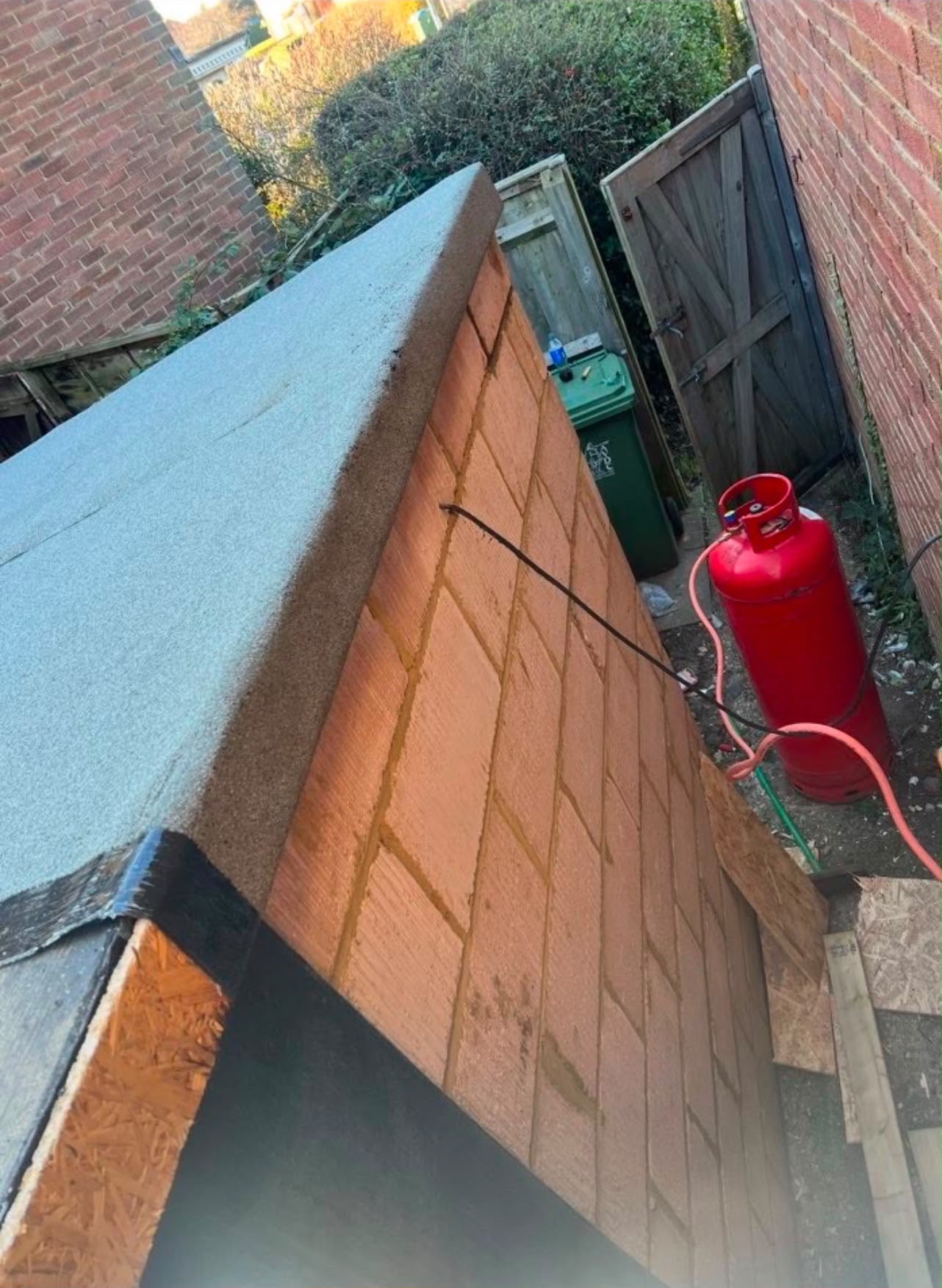 Completed mineral torch-on felt flat roof with a welted drip edge
