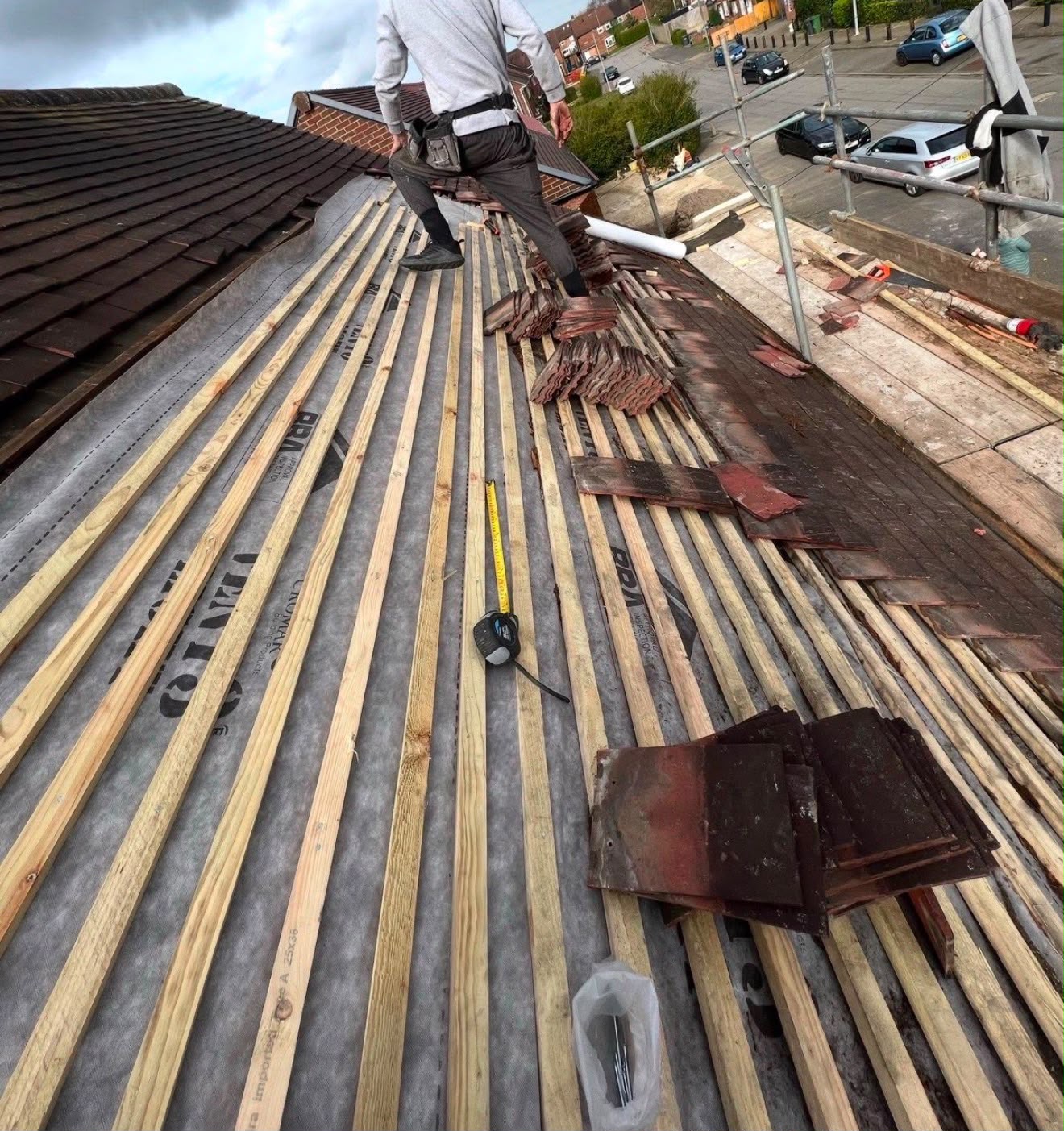 Ridge & Crown roofer fitting new battens over a breathable membrane during a full strip and re-tile